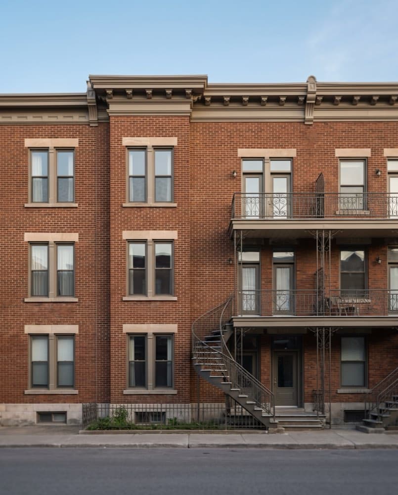 Brick apartment building facade in late afternoon light